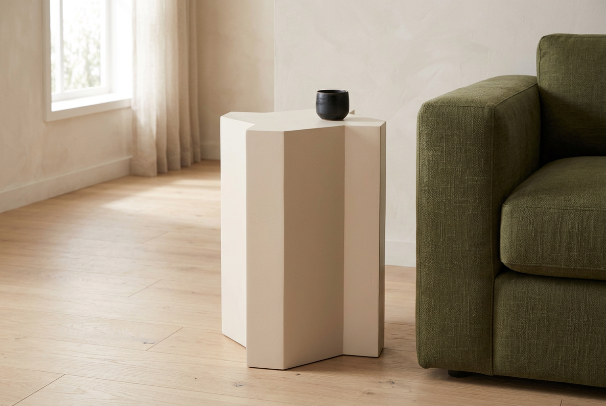 White Mamluk side table in a naturally lit living room with an olive sofa